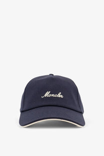 Navy blue moncler men’s cotton baseball hat with cream embroidered logo and matching trim in grey product line