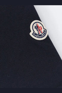 Dark navy blue moncler men’s cotton polo shirt with a classic embroidered logo patch in red white and black