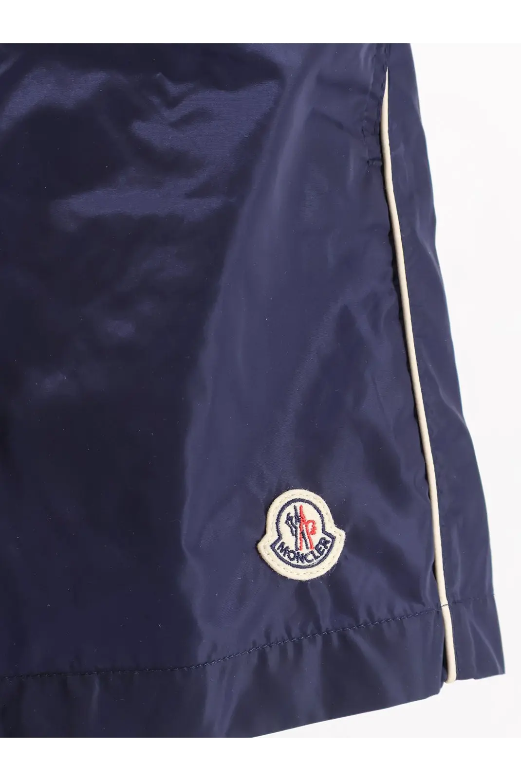 Moncler men’s navy blue nylon swim shorts with white seam detailing and embroidered logo patch on the front