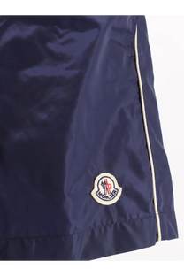 Moncler men’s navy blue nylon swim shorts with white seam detailing and embroidered logo patch on the front