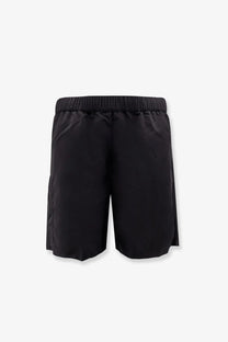 Moncler men’s nylon swim trunks in black with elastic waistband and side pockets for comfortable wear