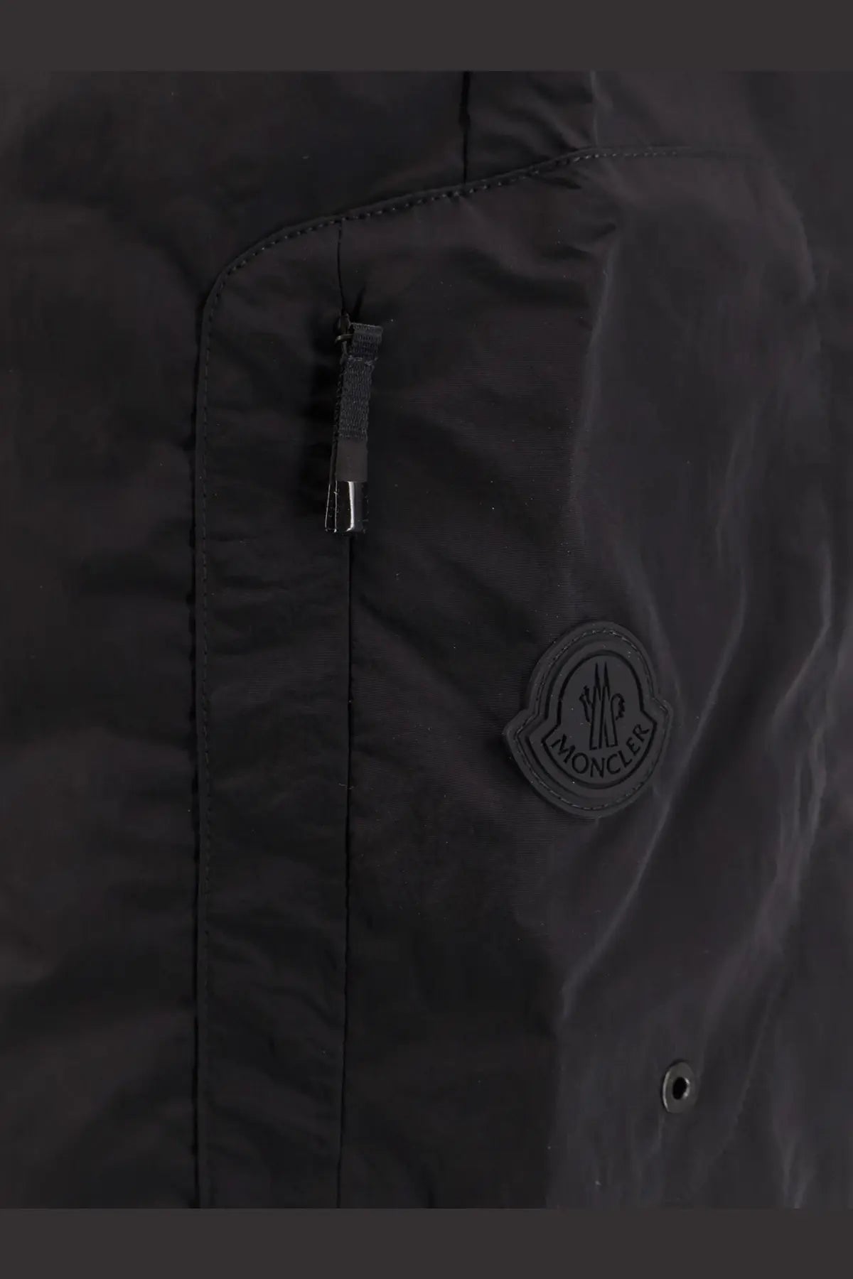 Black moncler nylon swim trunks with subtle sheen and circular logo patch on the chest for men