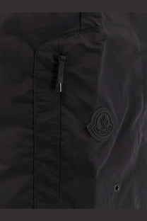 Black moncler nylon swim trunks with subtle sheen and circular logo patch on the chest for men