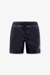 Moncler men’s nylon swim trunks in dark navy with a drawstring waistband and subtle brand logo on the side