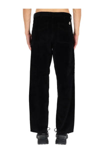 Back view of moncler men’s black ribbed corduroy pants with subtle texture and small white logo on back right pocket