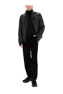 Moncler men’s ribbed pants black paired with a black quilted puffer jacket with glossy finish and brand logo on left shoulder