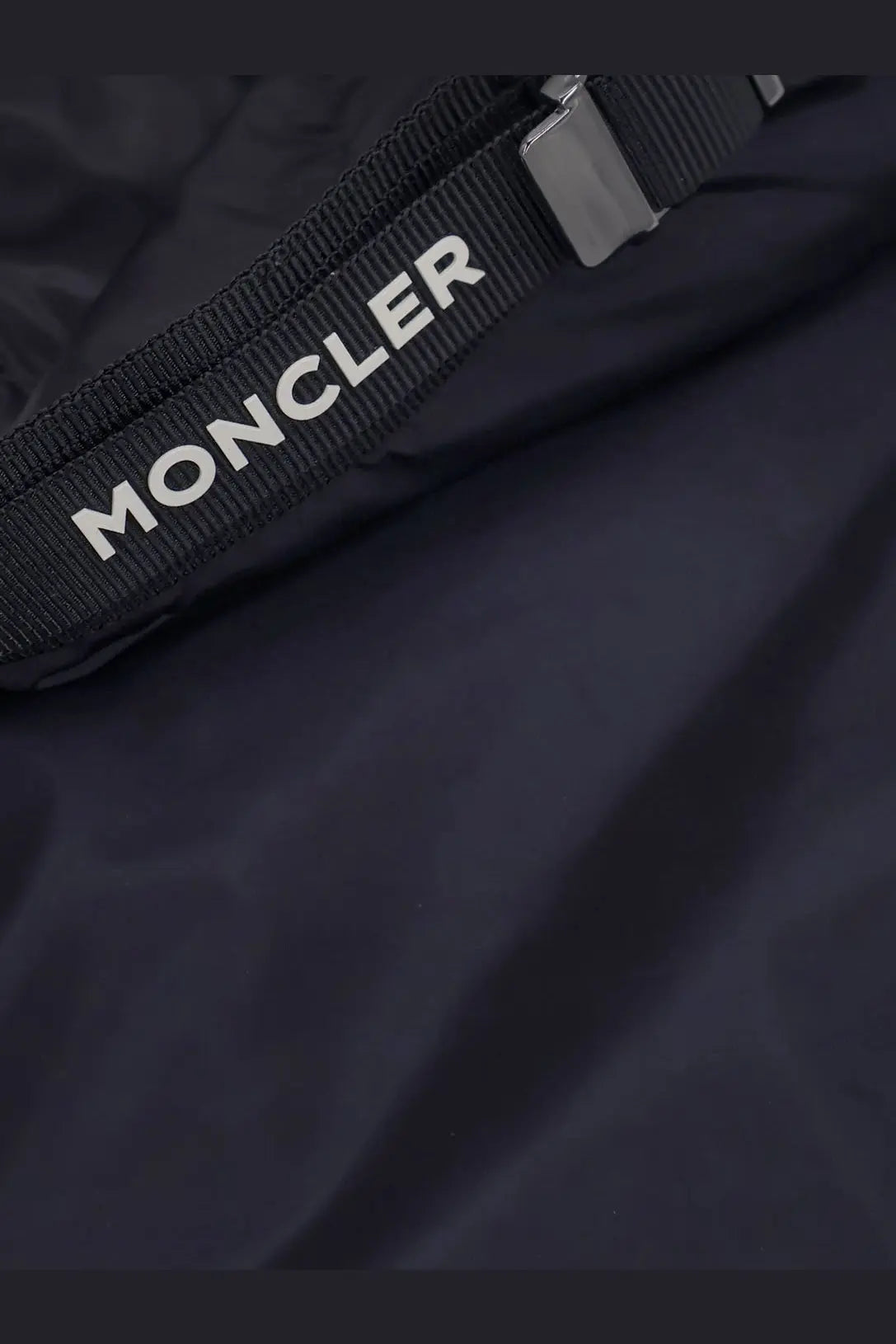 Black moncler strap with white lettering and metallic buckle on moncler men’s trestraou down jacket blue