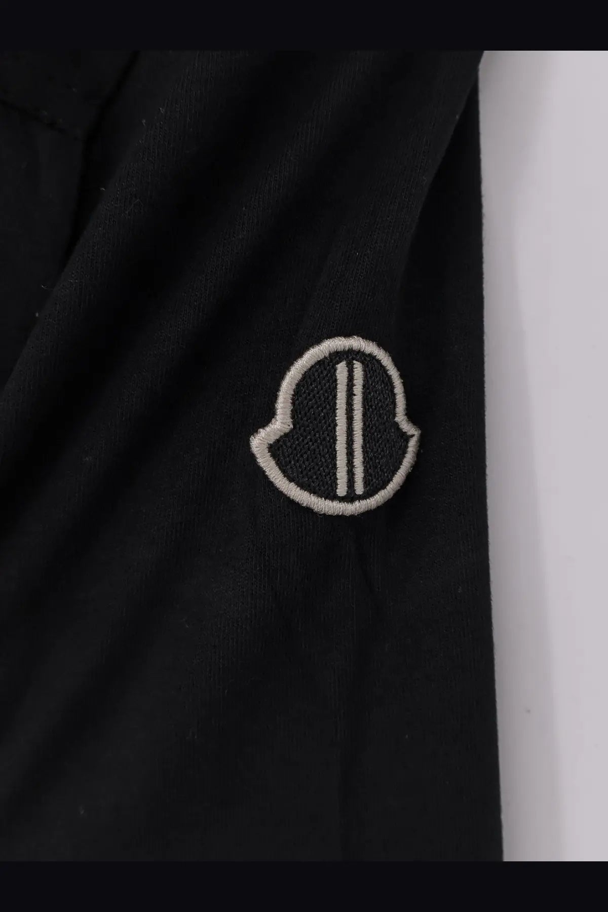 Black Moncler logo patch with white embroidery on the front of a Rick Owens Men’s Girder cotton shirt in black