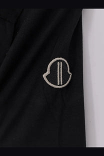 Black Moncler logo patch with white embroidery on the front of a Rick Owens Men’s Girder cotton shirt in black