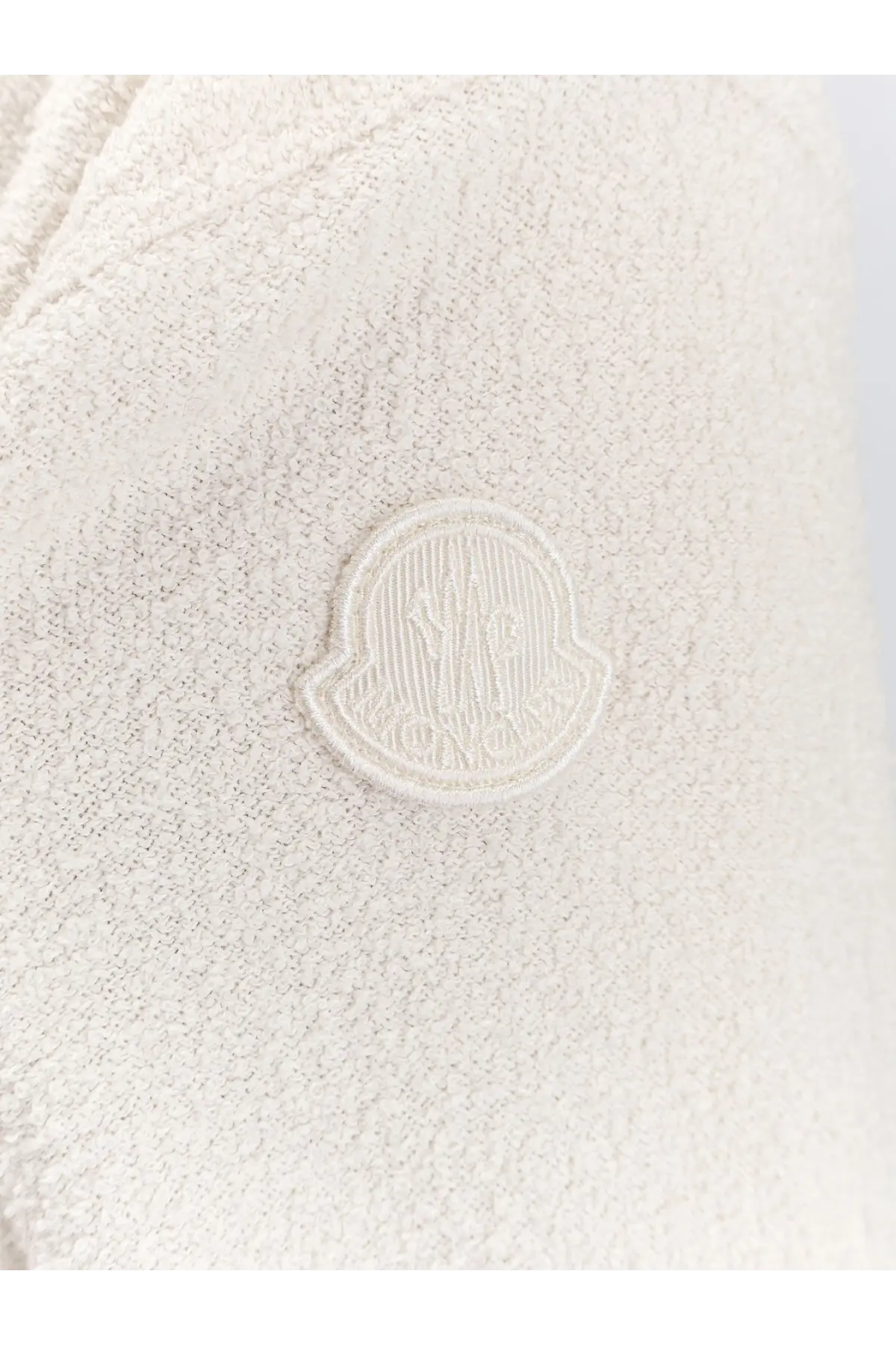 Cream-colored moncler logo patch embroidered on textured soft knit fabric of moncler women’s bouclé nylon jacket white