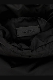 Black moncler brand label stitched into the interior lining of a dark nylon jacket for moncler women’s caradoc bag white