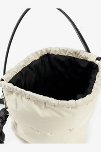 Moncler women’s cream-colored puffer bucket bag with black handles and black interior lining in water repellent fabric