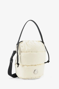 Moncler women’s caradoc cream puffer bucket bag with black leather handles and silver moncler logo plaque