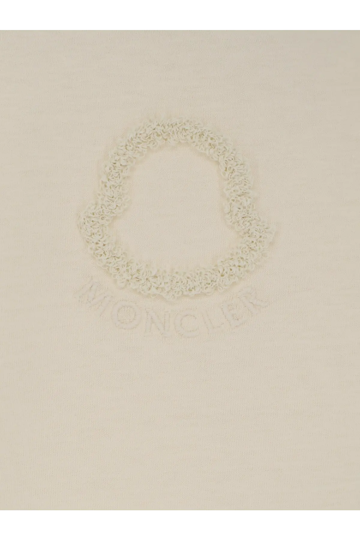 Cream-colored moncler logo embroidered on soft knit fabric of moncler women’s white cotton shirt front side