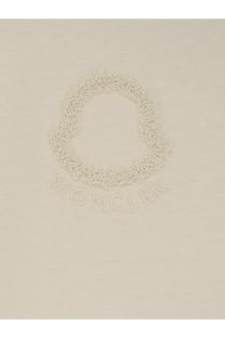 Cream-colored moncler logo embroidered on soft knit fabric of moncler women’s white cotton shirt front side