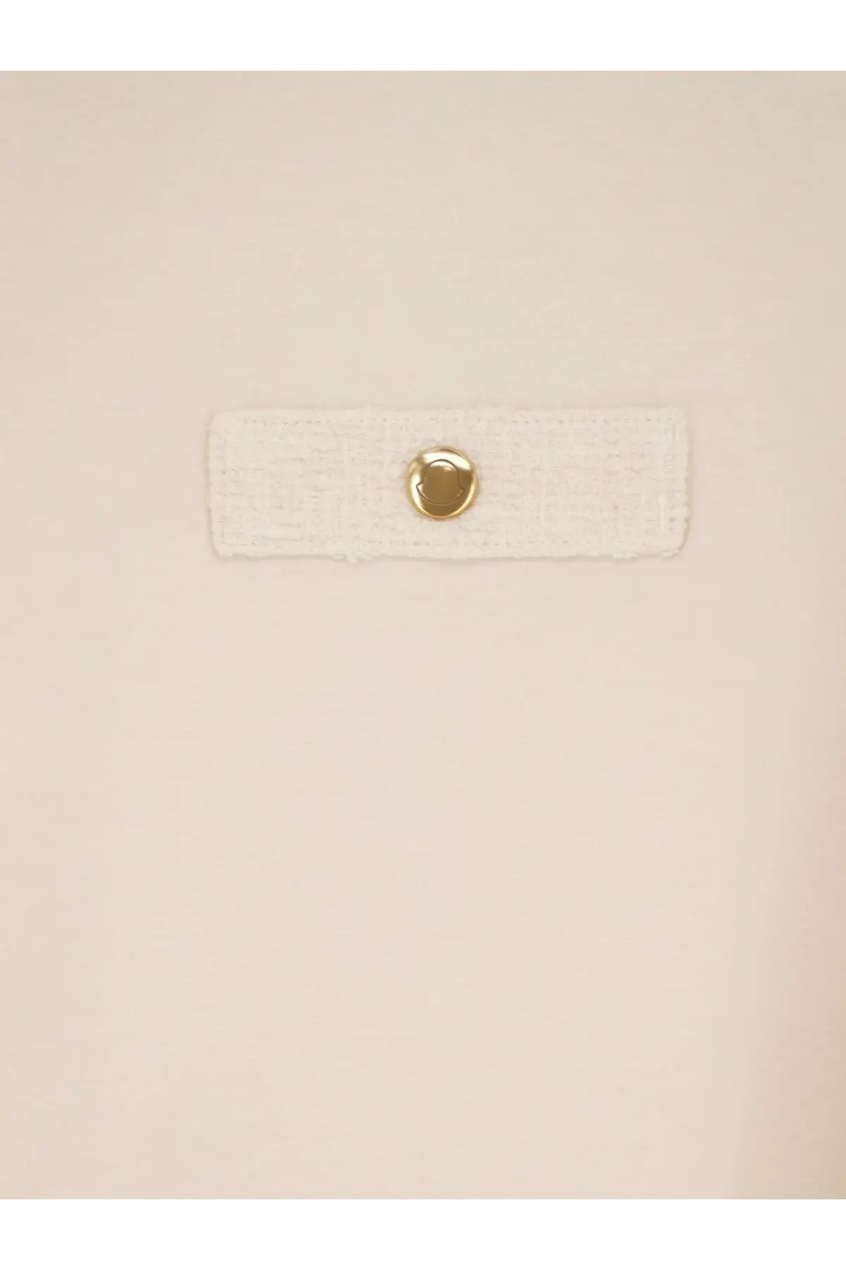 A cream-colored textured fabric strap with a gold-toned button on the back of moncler women’s white cotton shirt