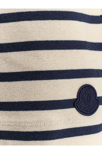 Moncler women’s black cotton shorts paired with cream-colored and navy blue striped knit top with embroidered logo patch