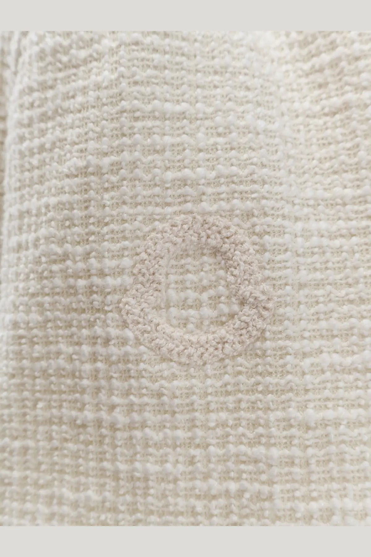 Cream-colored textured tweed fabric with a subtle woven circular pattern on moncler women’s dress white