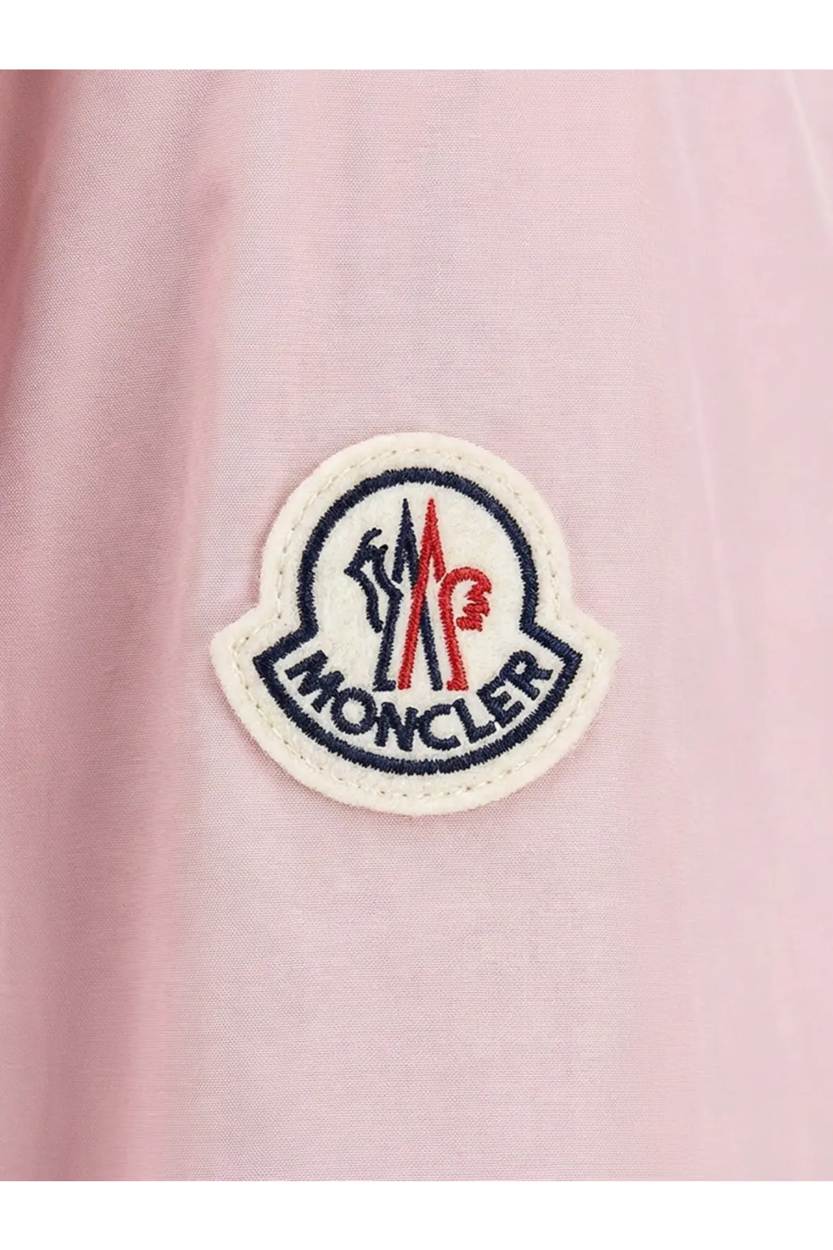 Pink moncler logo patch with embroidered red blue and white details on soft fabric of moncler women fegeos recycled jacket