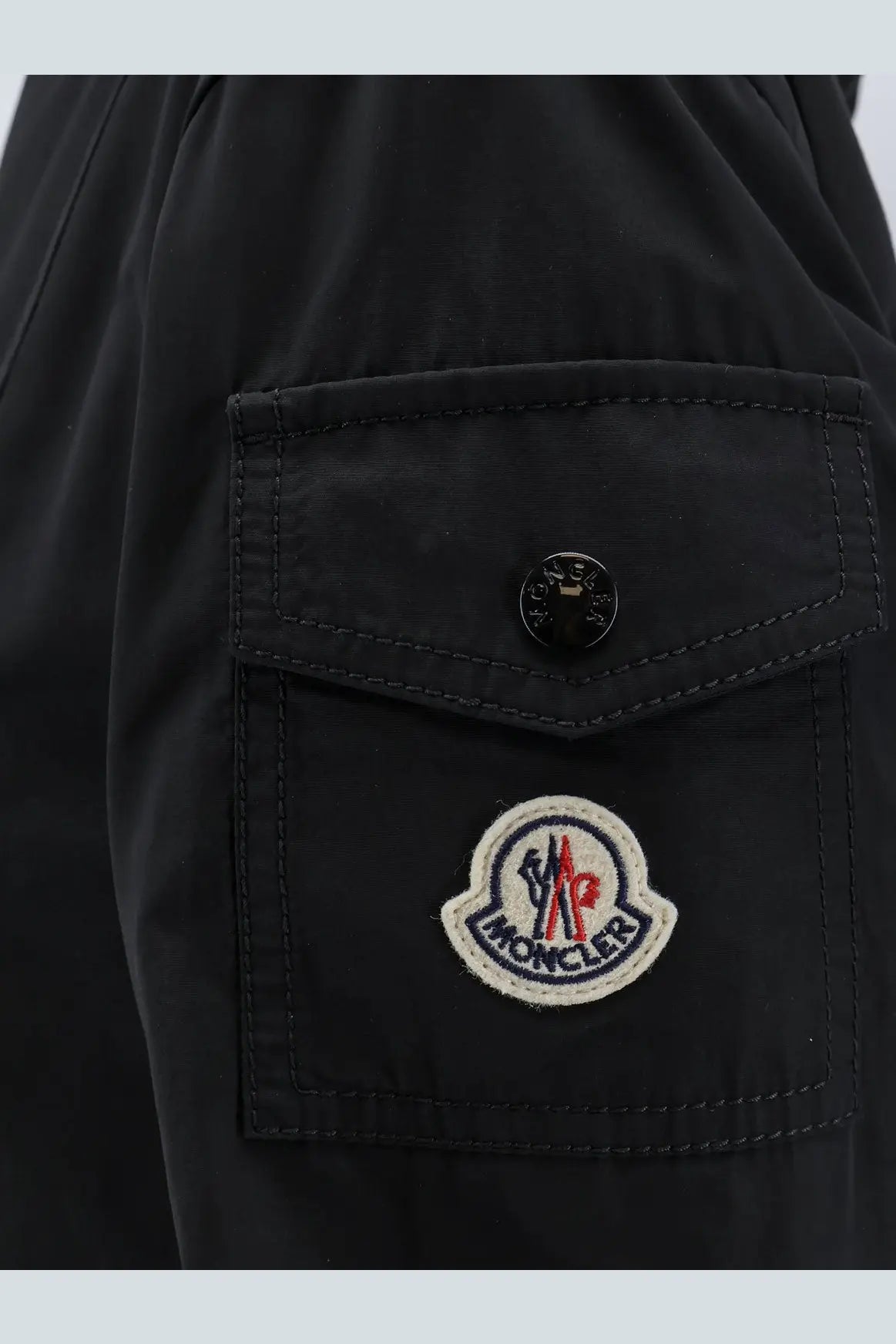Black moncler womens laerte cotton blend long jacket pocket with circular embroidered logo patch and black button
