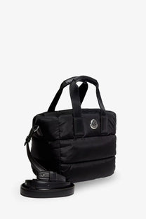 Moncler women’s black nylon Caradoc crossbody bag with quilted puffer texture and silver logo emblem on front
