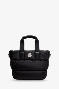 Moncler women’s black nylon puffer tote bag with quilted design and silver logo emblem for crossbody use