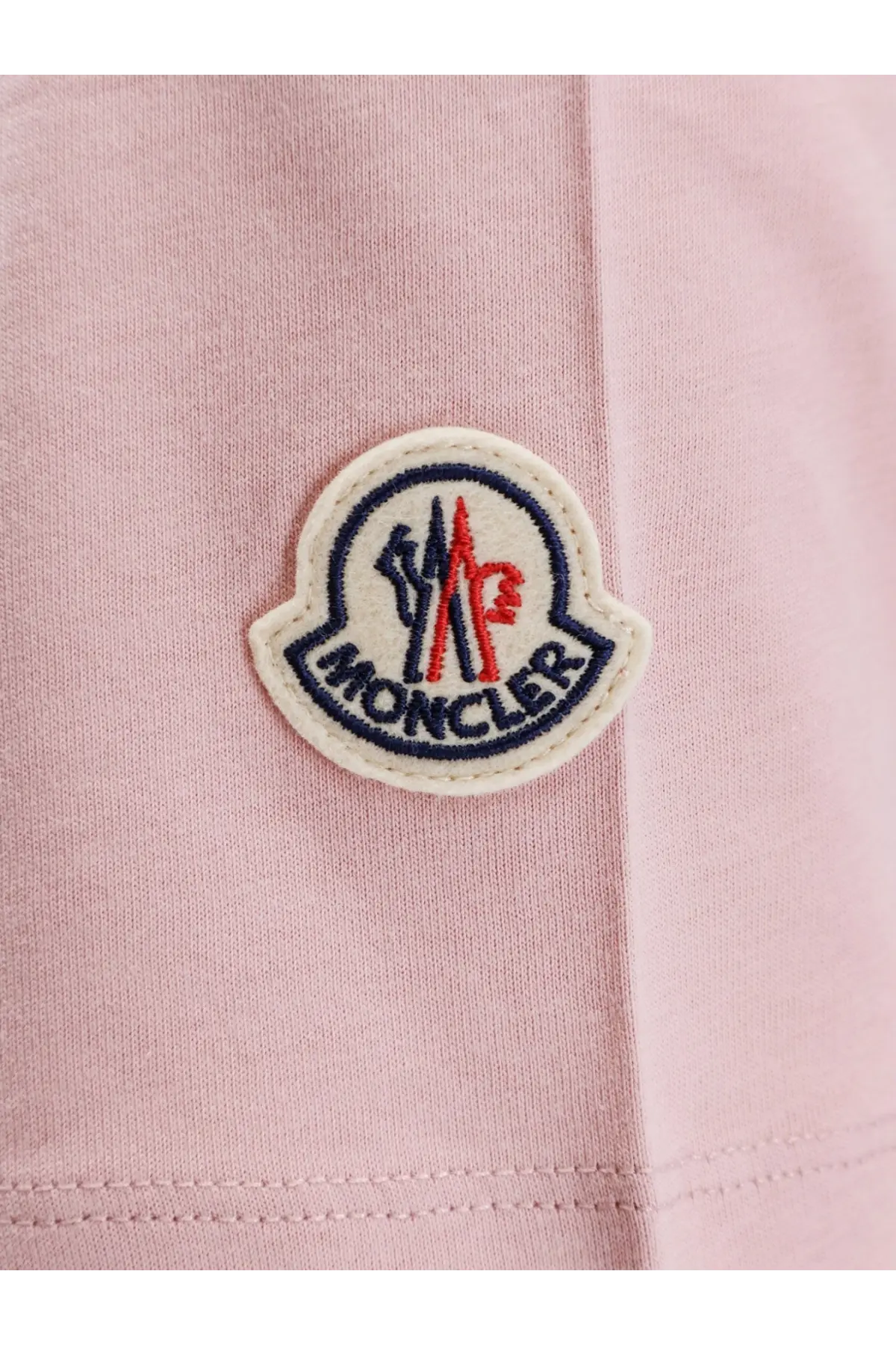 Pink moncler women’s organic cotton shirt with a pink embroidered patch featuring a red and black logo