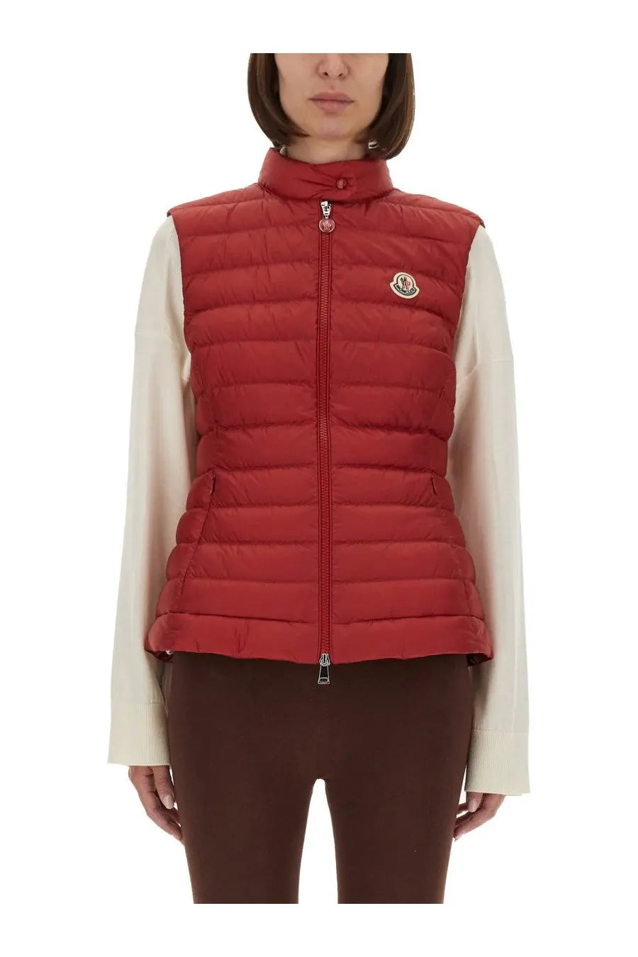 Moncler women’s padded vest igens in red features quilted material high collar and front zipper closure