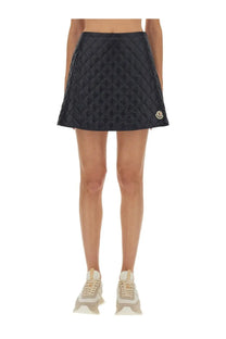 Moncler women’s black quilted mini skirt with diamond pattern and gold-tone logo patch on the side