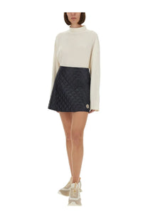 Moncler women’s black quilted mini skirt with subtle diamond pattern and small embroidered logo on the side