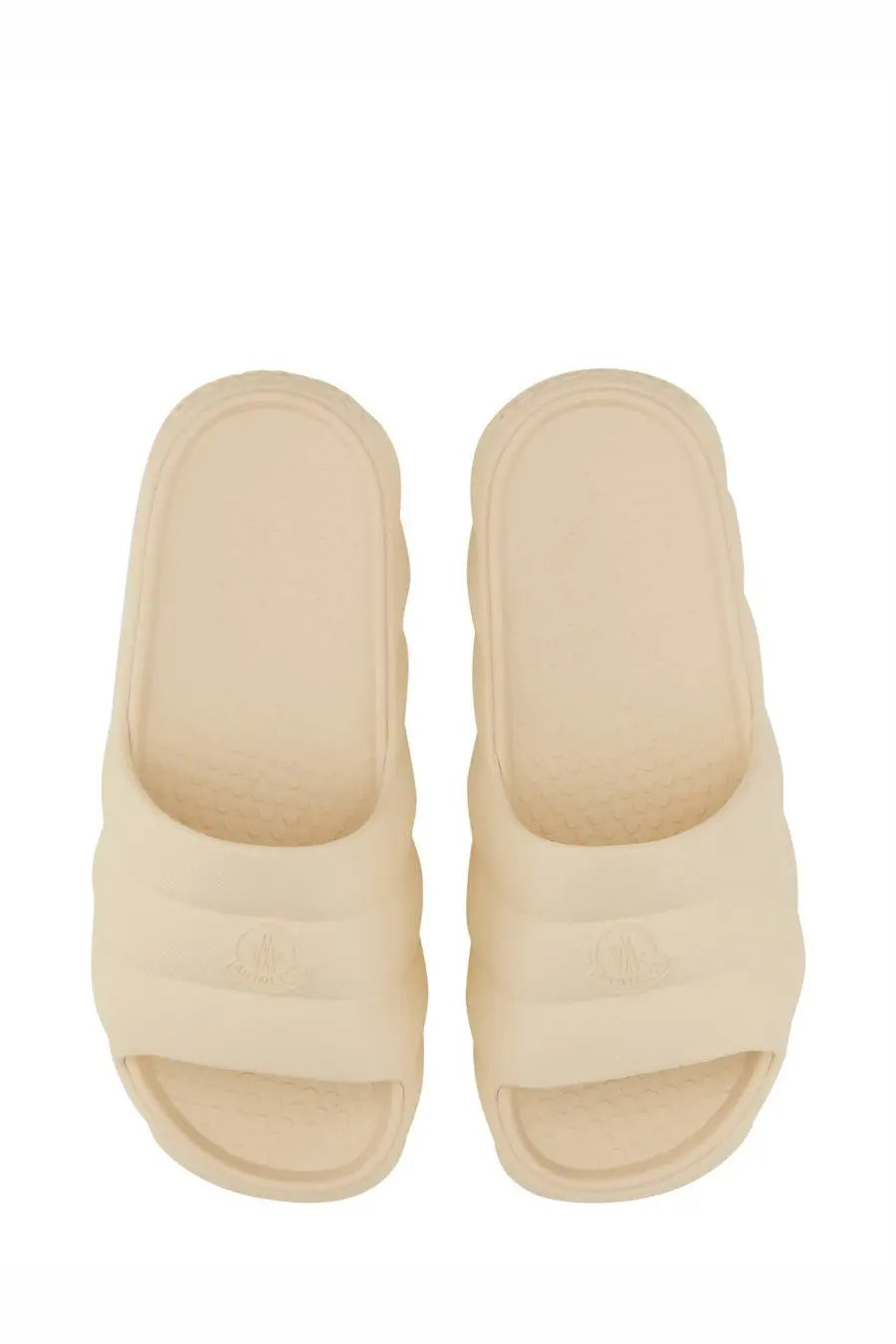 Moncler women’s cream-colored slide sandals with chunky soles minimalist design and subtle embossed logo on footbed