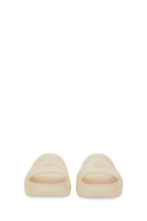 Moncler women’s cream-colored slide sandal with minimalist design and embossed Fendi logo on the footbed