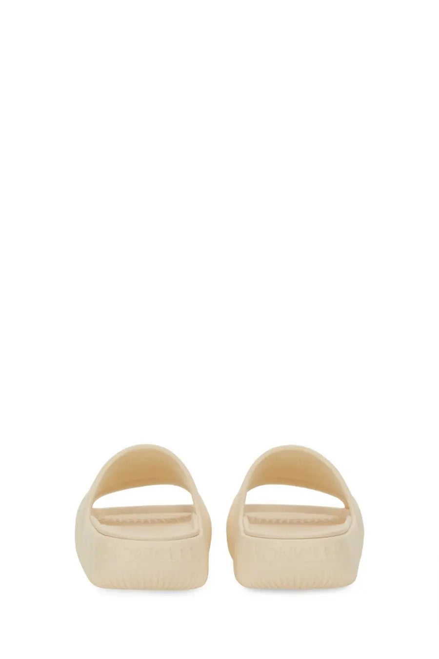 Moncler women’s cream-colored slide sandals with minimalist design and smooth molded rubber platform sole