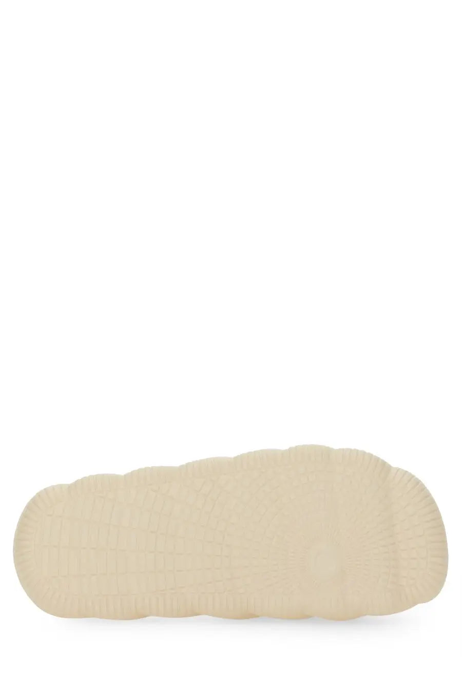 Cream-colored rubber sole with textured wavy pattern on the back side of moncler women’s slide sandal white