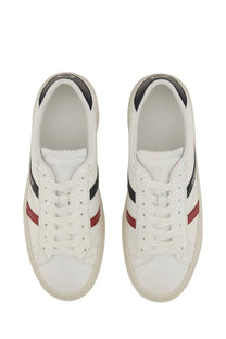Moncler women’s white leather sneakers with black and red stripes in a classic low-top design