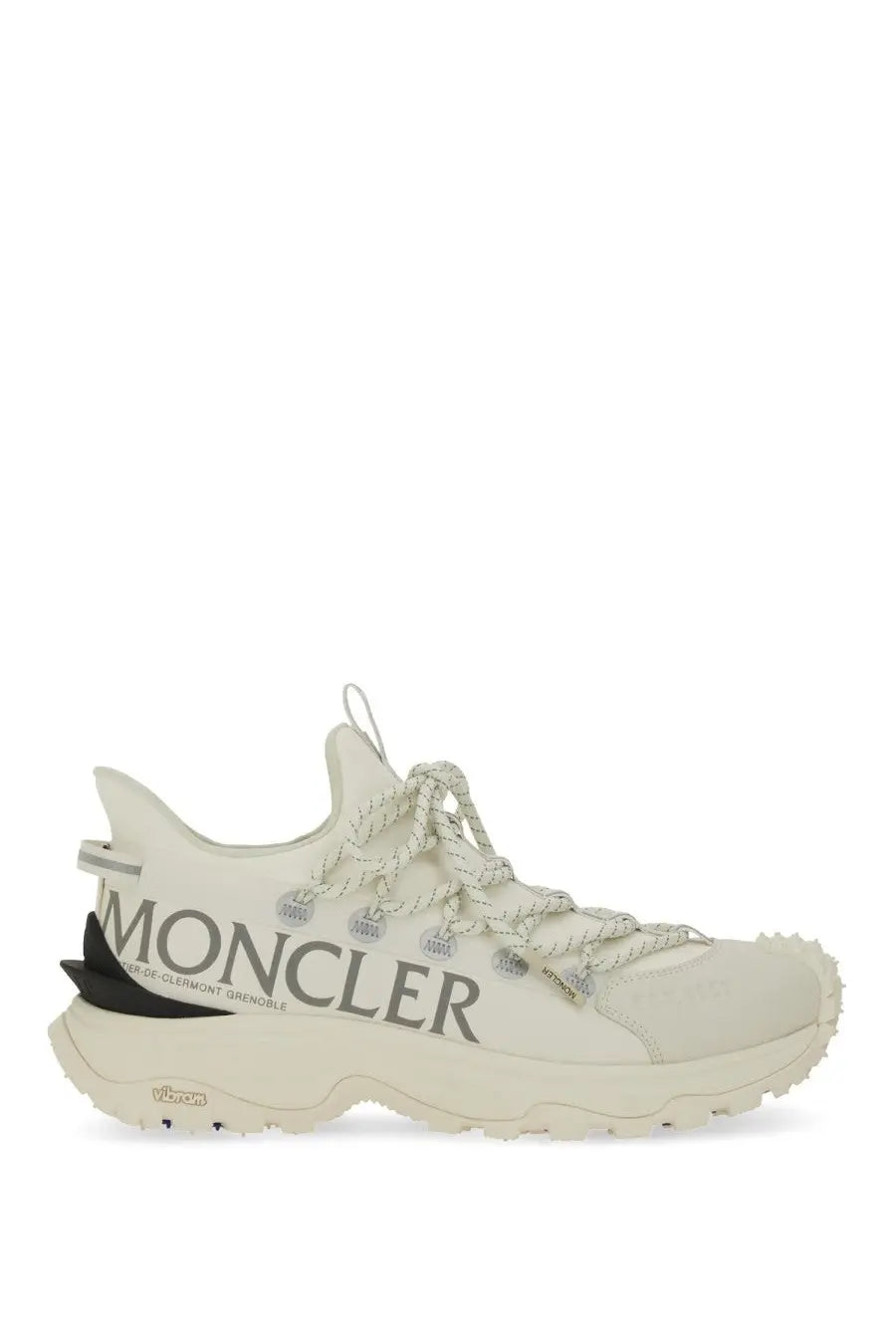 Cream-colored Moncler women’s Trailgrip Lite sneaker with textured upper, black heel tab, and bold gray branding