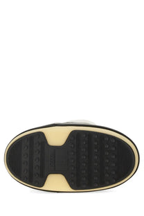 Black and cream rubber sole with textured tread and moonsoles branding on moon boot unisex icon boot multicolor