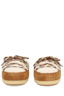 Tan suede slip-on mules with cream shearling lining and patterned laces from moon boot unisex shearling evx mules multicolor