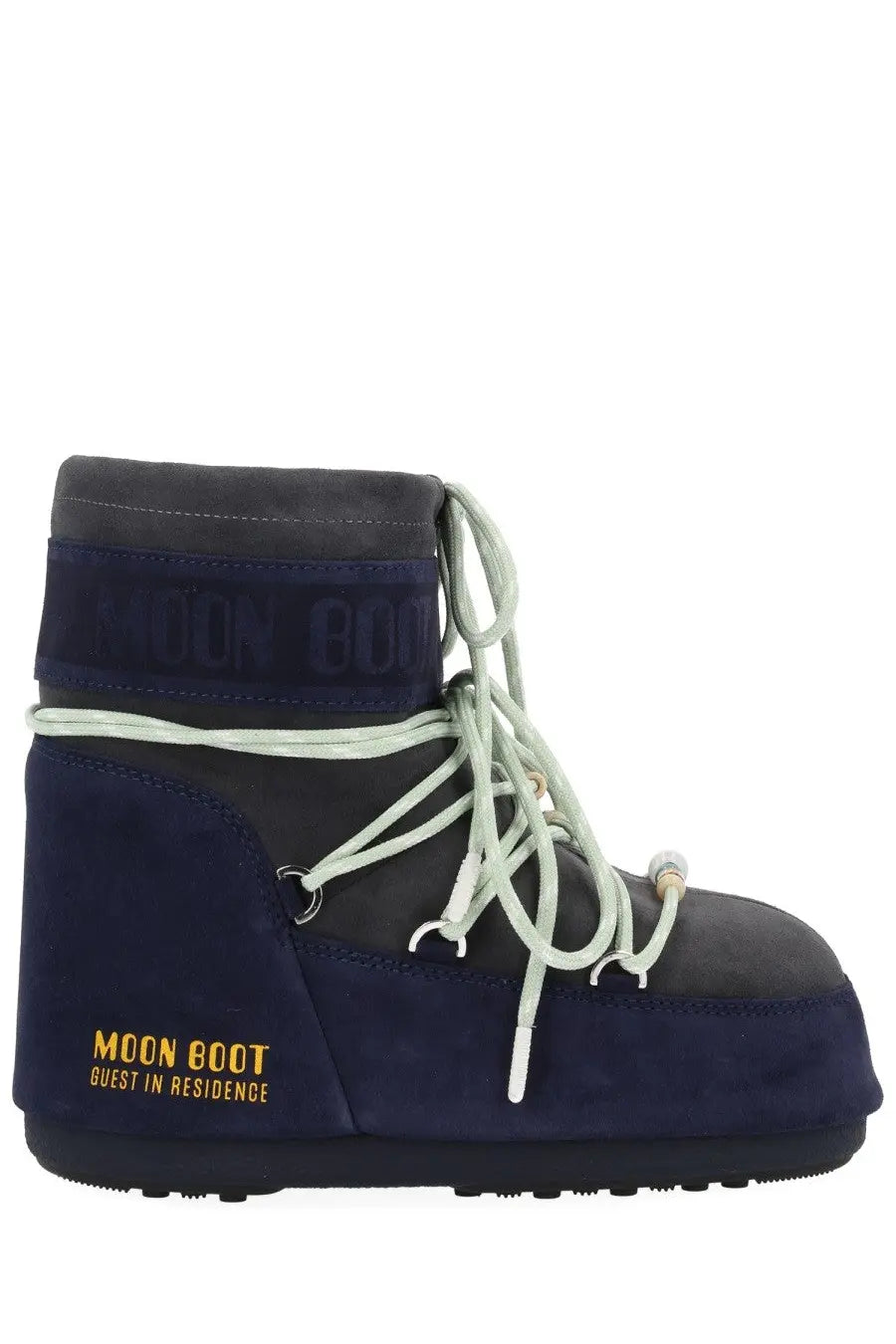 Navy blue suede moon boot with light gray laces and gold branding from moon boot women’s guest in residence collection