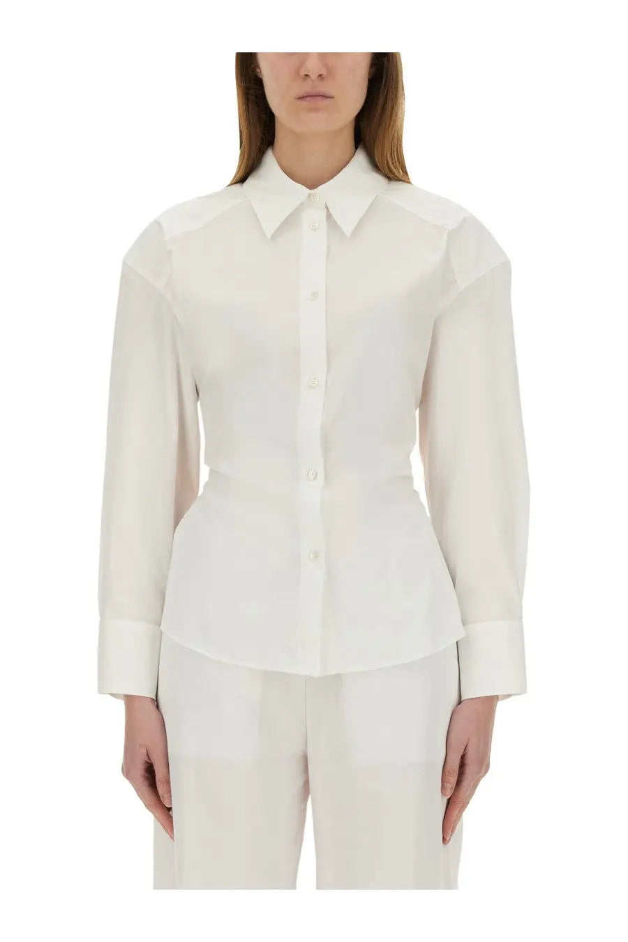 A crisp white long-sleeved Moschino Jeans cotton blouse with a structured collar and peplum hem