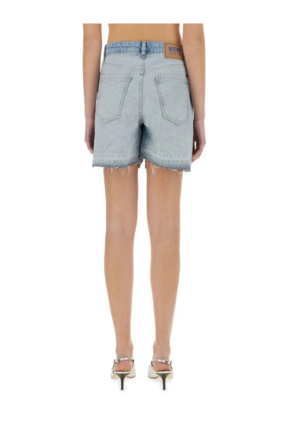 Light-wash denim shorts with frayed hem and back pockets featuring brown leather brand patch on waistband from moschino jeans