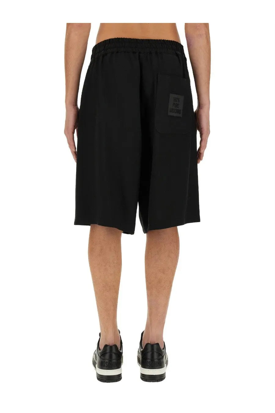 Back side of moschino men’s bermuda black athletic shorts with elastic waistband and rectangular patch on pocket