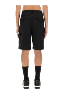 Moschino men’s Bermuda black cargo shorts in structured fabric with two back flap pockets and side pockets shown from back
