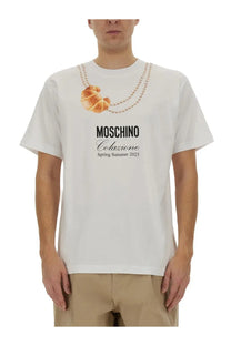 Moschino men’s white cotton t-shirt with golden brown croissant print on beaded necklace and spring summer 2025 text