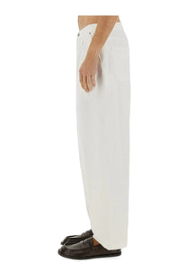 Moschino men’s jeans in denim white featuring white wide-leg trousers with a minimalist design and subtle front pockets