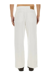 White wide-leg denim trousers with tan leather patch at waistband from moschino mens jeans in denim white