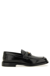 Moschino men’s Berlin black patent leather loafer with gold-tone logo medallion on the vamp