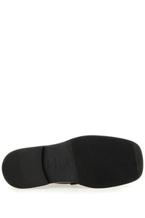Black rubber sole with textured grip and embossed Moschino logo on the back of men’s Berlin black moccasin