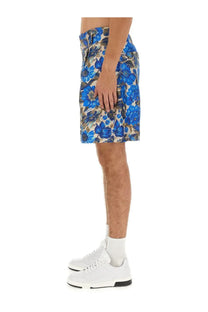 Moschino men’s shorts with blue floral pattern on beige base and dark green accents perfect for casual wear
