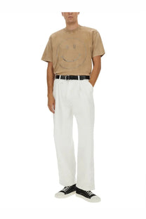 Beige Moschino men’s heavy cotton t-shirt with short sleeves featuring a smiling face design with silver studs and chains